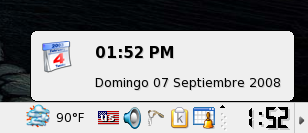 Hovering over the clock shows the date in Spanish